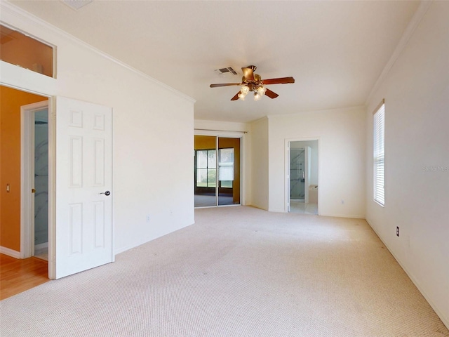 7985 Saint Giles Pl, Orlando, FL 32835 - spare room featuring light carpet, a ceiling fan, and crown molding