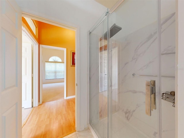 7985 Saint Giles Pl, Orlando, FL 32835 - full bathroom featuring a marble finish shower and wood finished floors