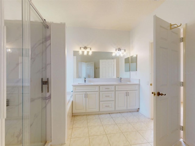 7985 Saint Giles Pl, Orlando, FL 32835 - bathroom with a marble finish shower, double vanity, tile patterned floors, and a tub