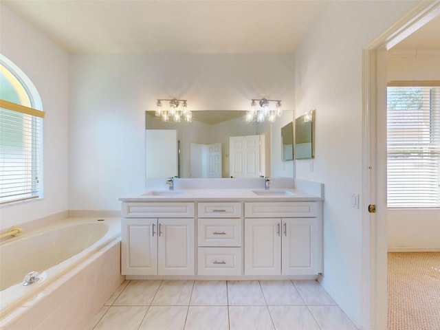 7985 Saint Giles Pl, Orlando, FL 32835 - full bathroom featuring double vanity, a garden tub, and tile patterned flooring