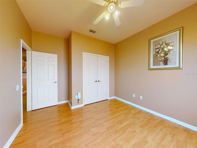7985 Saint Giles Pl, Orlando, FL 32835 - unfurnished bedroom featuring light wood-style flooring, a closet, and ceiling fan