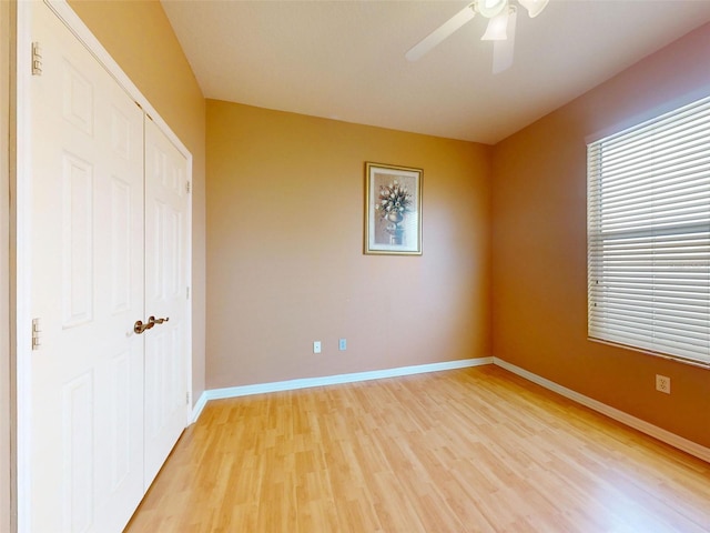 7985 Saint Giles Pl, Orlando, FL 32835 - unfurnished bedroom with light wood-type flooring, a closet, and ceiling fan