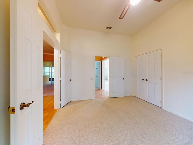 7985 Saint Giles Pl, Orlando, FL 32835 - unfurnished bedroom featuring carpet flooring, a ceiling fan, and a closet