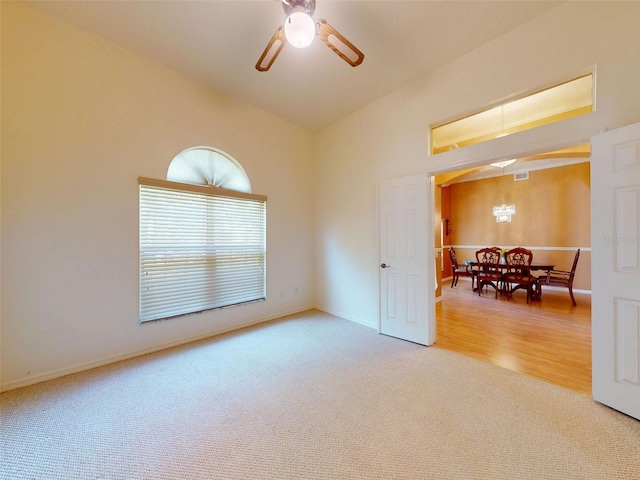 7985 Saint Giles Pl, Orlando, FL 32835 - spare room with carpet flooring, a ceiling fan, and vaulted ceiling