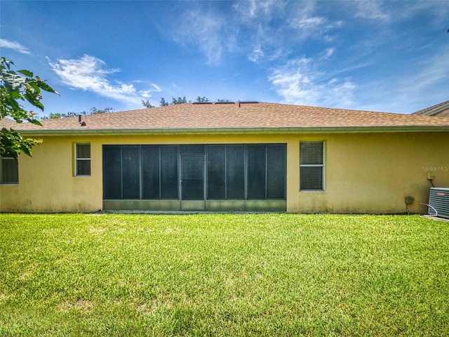 7985 Saint Giles Pl, Orlando, FL 32835 - rear view of house with stucco siding, a yard, and a sunroom