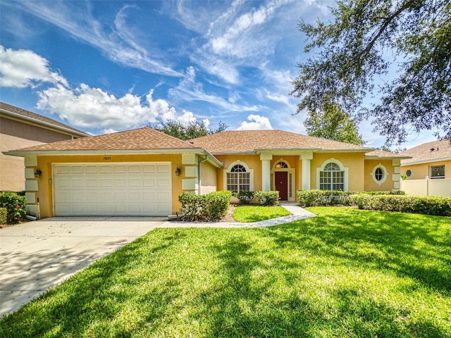 7985 Saint Giles Pl, Orlando, FL 32835 - view of front of house with an attached garage, concrete driveway, stucco siding, and a front yard
