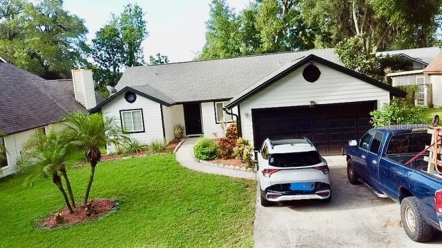 957 Southridge Trl, Altamonte Springs, FL 32714 - ranch-style house featuring a garage, a front lawn, and driveway