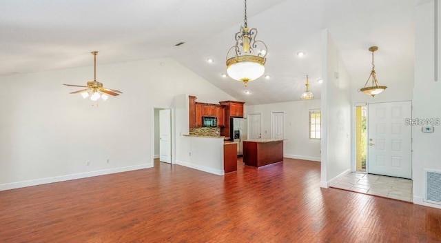 957 Southridge Trl, Altamonte Springs, FL 32714 - unfurnished living room with high vaulted ceiling, wood finished floors, and ceiling fan