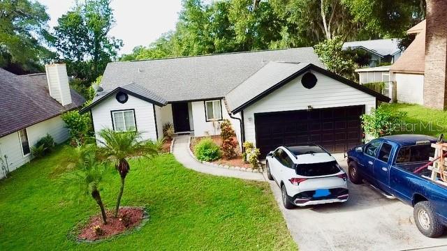 957 Southridge Trl, Altamonte Springs, FL 32714 - single story home with driveway, a front yard, and a garage
