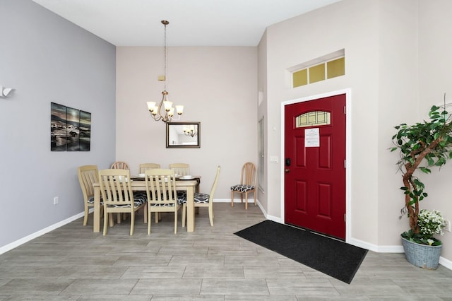 1520 Gulf Vue Dr, Haines City, FL 33844 - foyer entrance with a chandelier, a high ceiling, and light wood-type flooring