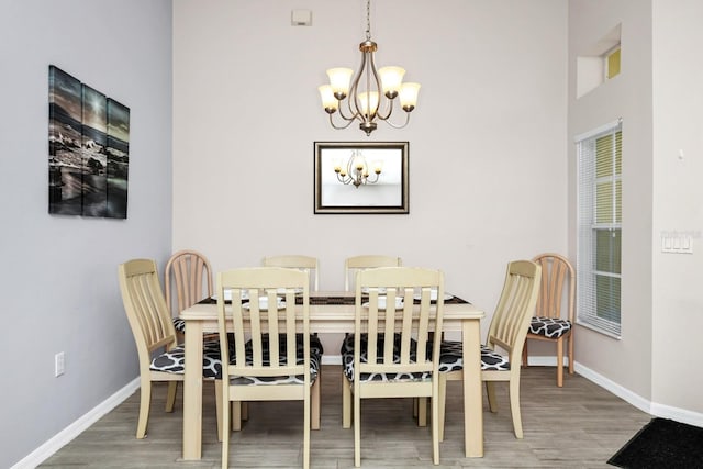 1520 Gulf Vue Dr, Haines City, FL 33844 - dining area with a chandelier, wood finished floors, and a high ceiling