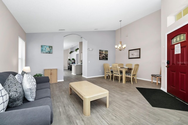 1520 Gulf Vue Dr, Haines City, FL 33844 - living area featuring a chandelier, wood finished floors, arched walkways, and lofted ceiling