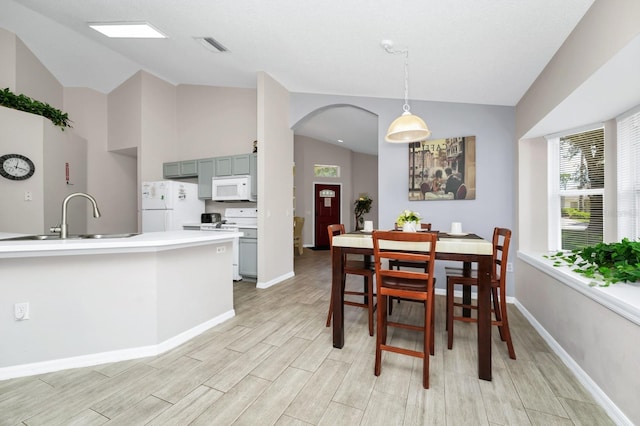 1520 Gulf Vue Dr, Haines City, FL 33844 - dining room featuring wood tiled floors, arched walkways, and high vaulted ceiling