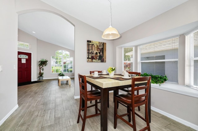 1520 Gulf Vue Dr, Haines City, FL 33844 - dining area with lofted ceiling, light wood finished floors, and arched walkways
