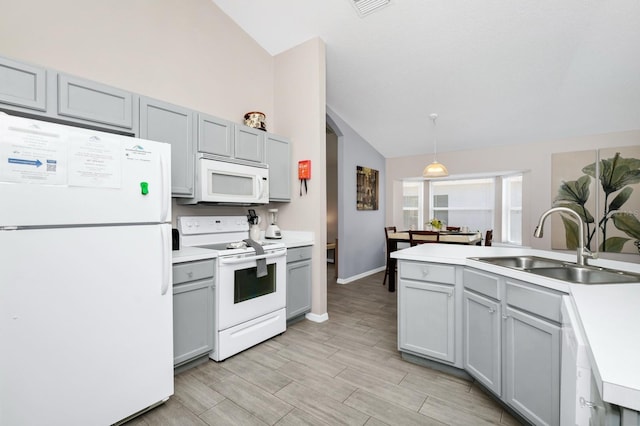 1520 Gulf Vue Dr, Haines City, FL 33844 - kitchen featuring white appliances, gray cabinetry, light countertops, light wood finished floors, and decorative light fixtures