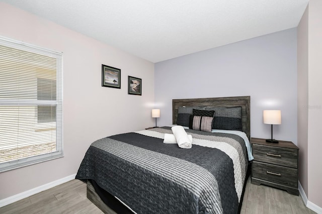 1520 Gulf Vue Dr, Haines City, FL 33844 - bedroom featuring wood finished floors and multiple windows