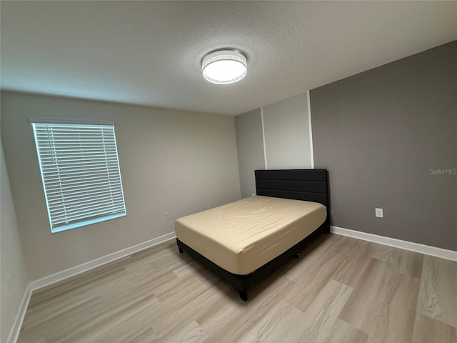 18219 Oliver Twist Way, Winter Garden, FL 34787 - bedroom featuring light wood-style flooring and a textured ceiling