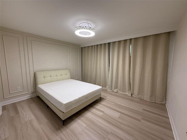 18219 Oliver Twist Way, Winter Garden, FL 34787 - bedroom featuring light wood-style floors and baseboards