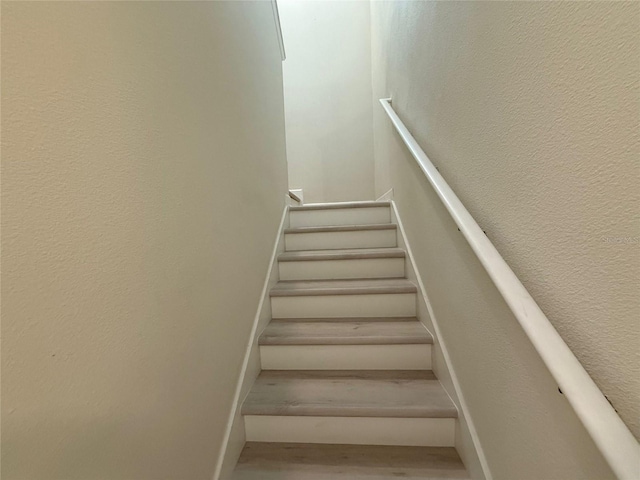 18219 Oliver Twist Way, Winter Garden, FL 34787 - staircase featuring wood finished floors and baseboards