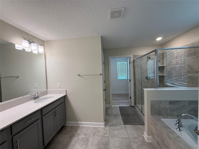 18219 Oliver Twist Way, Winter Garden, FL 34787 - full bath with a garden tub, vanity, a stall shower, tile patterned flooring, and a textured ceiling