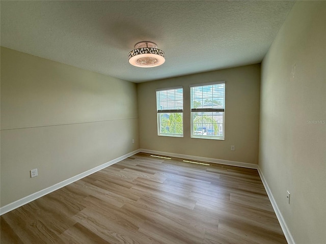 18219 Oliver Twist Way, Winter Garden, FL 34787 - unfurnished room featuring wood finished floors and a textured ceiling