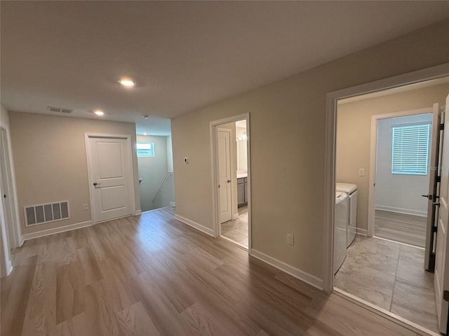 18219 Oliver Twist Way, Winter Garden, FL 34787 - empty room with washer and dryer, light wood finished floors, and recessed lighting