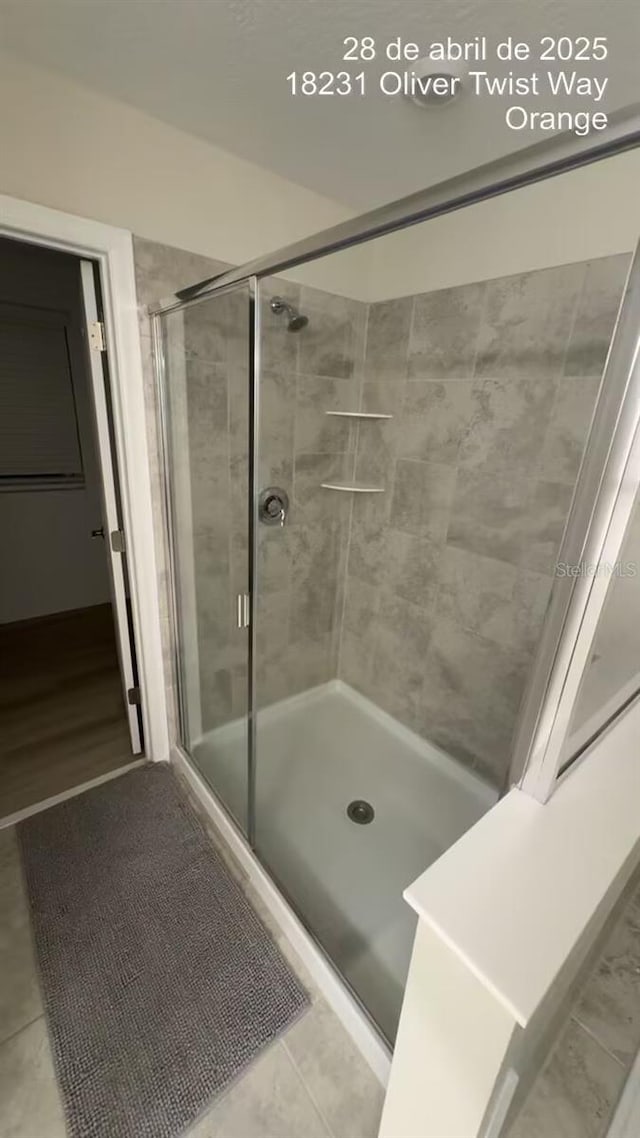 18219 Oliver Twist Way, Winter Garden, FL 34787 - bathroom with a stall shower and tile patterned flooring