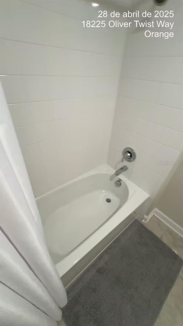 18219 Oliver Twist Way, Winter Garden, FL 34787 - full bathroom featuring shower / tub combo and tile patterned flooring