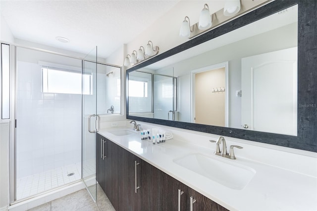 207 Macaulays Cv, Haines City, FL 33844 - full bathroom with a shower stall, double vanity, and tile patterned flooring