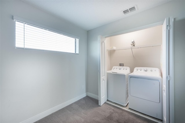 207 Macaulays Cv, Haines City, FL 33844 - laundry room featuring washer and clothes dryer and carpet floors