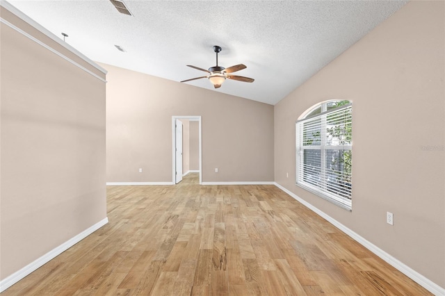3245 Kings Ridge Ter, Deltona, FL 32725 - spare room with a ceiling fan, vaulted ceiling, a textured ceiling, and light wood-type flooring