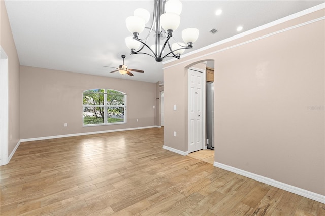3245 Kings Ridge Ter, Deltona, FL 32725 - unfurnished room with arched walkways, a ceiling fan, light wood-type flooring, and a chandelier
