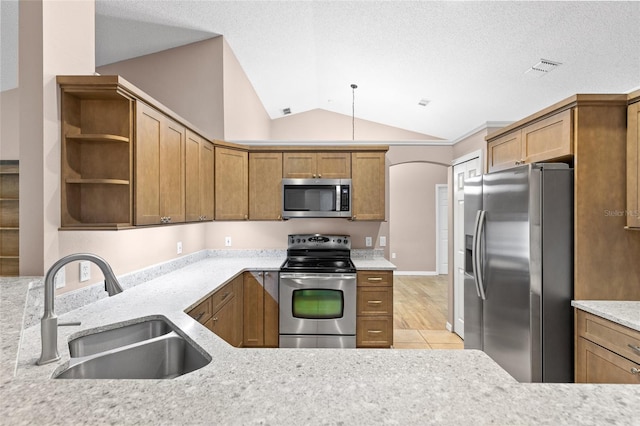 3245 Kings Ridge Ter, Deltona, FL 32725 - kitchen featuring stainless steel appliances, lofted ceiling, open shelves, brown cabinetry, and light stone countertops
