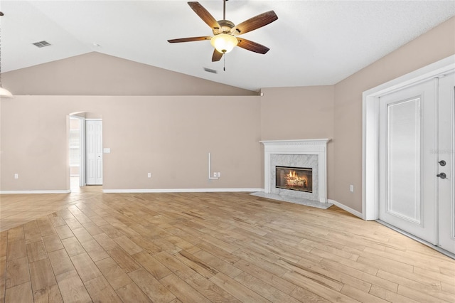 3245 Kings Ridge Ter, Deltona, FL 32725 - unfurnished living room with a ceiling fan, light wood-style flooring, a high end fireplace, and lofted ceiling
