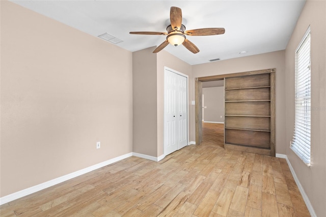 3245 Kings Ridge Ter, Deltona, FL 32725 - unfurnished bedroom featuring light wood-type flooring, multiple windows, a ceiling fan, and a closet