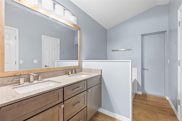 3245 Kings Ridge Ter, Deltona, FL 32725 - full bathroom featuring lofted ceiling, double vanity, wood finished floors, and a tub