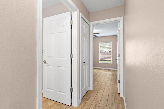 3245 Kings Ridge Ter, Deltona, FL 32725 - corridor featuring a textured ceiling and light wood-style flooring