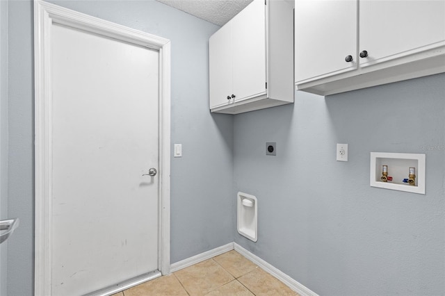 3245 Kings Ridge Ter, Deltona, FL 32725 - washroom with electric dryer hookup, cabinet space, washer hookup, light tile patterned floors, and a textured ceiling