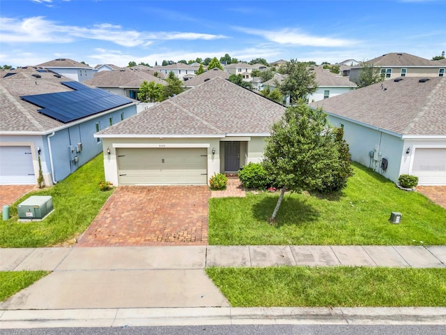 9370 Westmorely St, Groveland, FL 34736 - ranch-style home with roof with shingles, an attached garage, decorative driveway, stucco siding, and a residential view