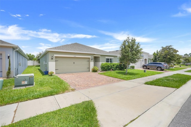 9370 Westmorely St, Groveland, FL 34736 - single story home featuring decorative driveway, a garage, stucco siding, and a front lawn