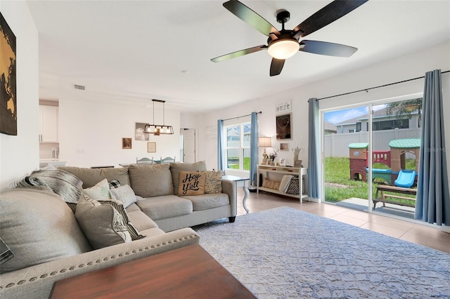 9370 Westmorely St, Groveland, FL 34736 - living area with ceiling fan, a chandelier, healthy amount of natural light, and tile patterned flooring