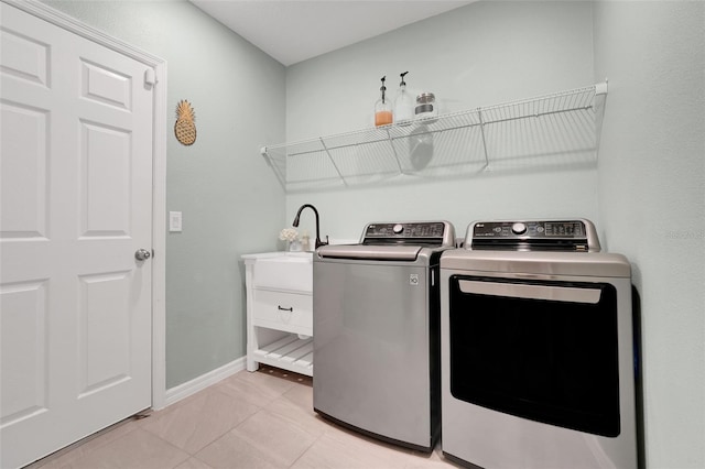 9370 Westmorely St, Groveland, FL 34736 - laundry room featuring separate washer and dryer and light tile patterned floors