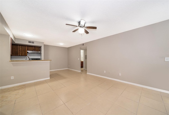 5140 Conroy Rd Unit 16, Orlando, FL 32811 - unfurnished living room featuring a ceiling fan, light tile patterned flooring, and a textured ceiling