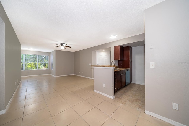 5140 Conroy Rd Unit 16, Orlando, FL 32811 - kitchen featuring ceiling fan, light tile patterned flooring, a peninsula, open floor plan, and a textured ceiling