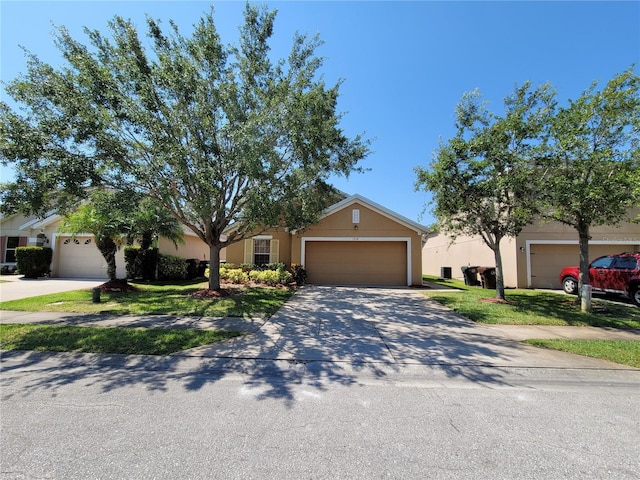 1914 Commander Way, Kissimmee, FL 34746 - view of front of house with an attached garage, concrete driveway, and stucco siding