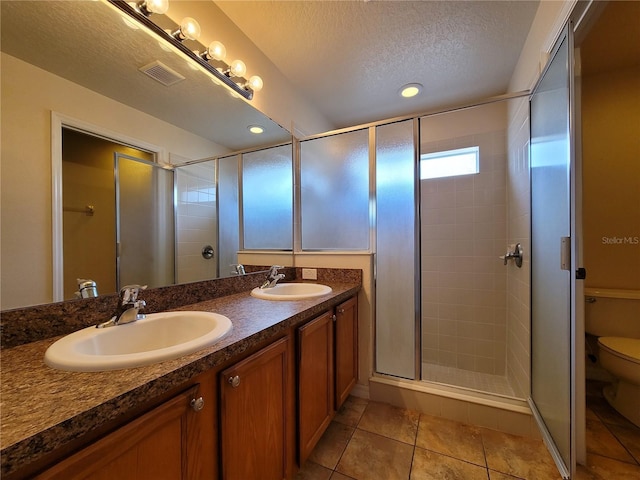 1914 Commander Way, Kissimmee, FL 34746 - bathroom with a stall shower, a textured ceiling, double vanity, tile patterned flooring, and recessed lighting