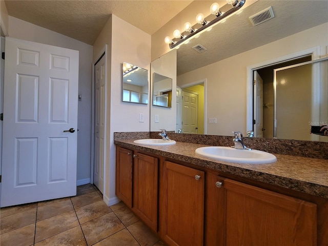 1914 Commander Way, Kissimmee, FL 34746 - bathroom with double vanity, tile patterned floors, and a textured ceiling