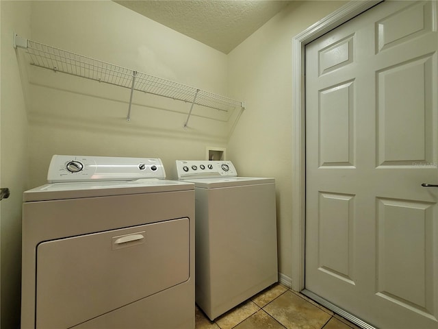 1914 Commander Way, Kissimmee, FL 34746 - washroom featuring independent washer and dryer, a textured ceiling, and light tile patterned floors