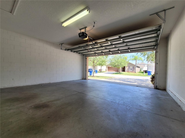1914 Commander Way, Kissimmee, FL 34746 - garage featuring a garage door opener and concrete block wall
