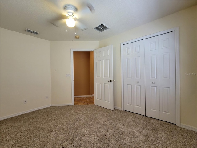 1914 Commander Way, Kissimmee, FL 34746 - unfurnished bedroom with light carpet, a closet, and a ceiling fan